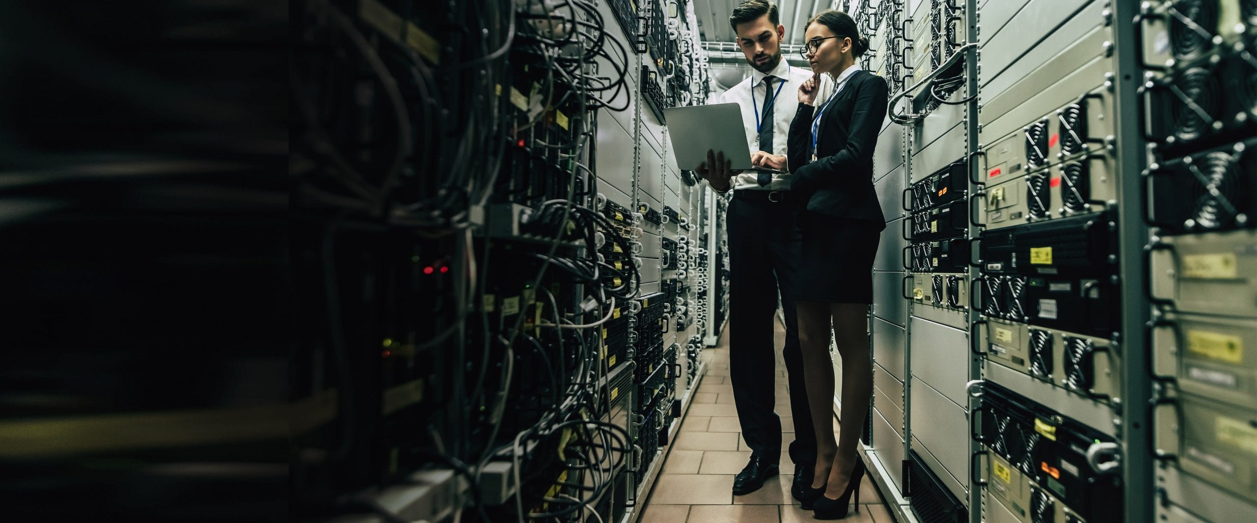 Woman with tablet diagnosing server hardware