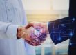 close up hand of young Arabian man in white suit handshake after finishing up meeting with graphic network diagram, partnership, teamwork, technology, connection, financial and investment concept